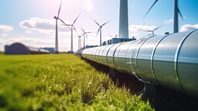 Eine Wasserstoff-Pipeline mit Windturbinen im Hintergrund