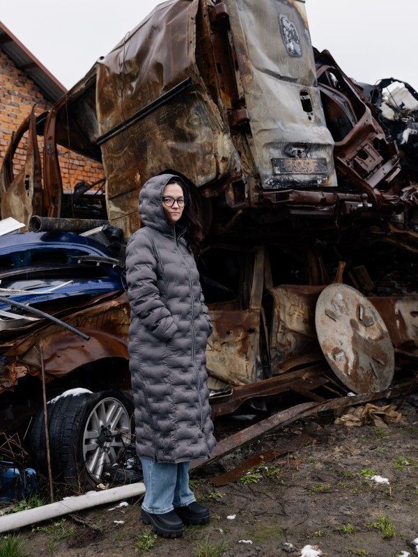 Khrystyna Stelmashchuk in front of the cars that were destroyed on the day of the attack. The Stelmashchuk family's car repair shop in Lviv was largely destroyed by a Russian missile. 