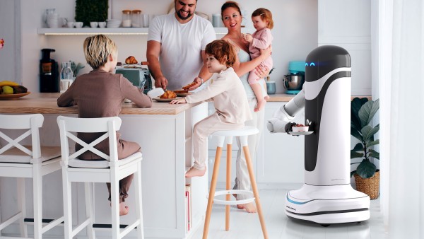 A family together with a robot in the kitchen